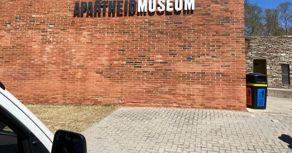 Small tour group outside the Apartheid Museum on a full day Johannesburg and Soweto tour