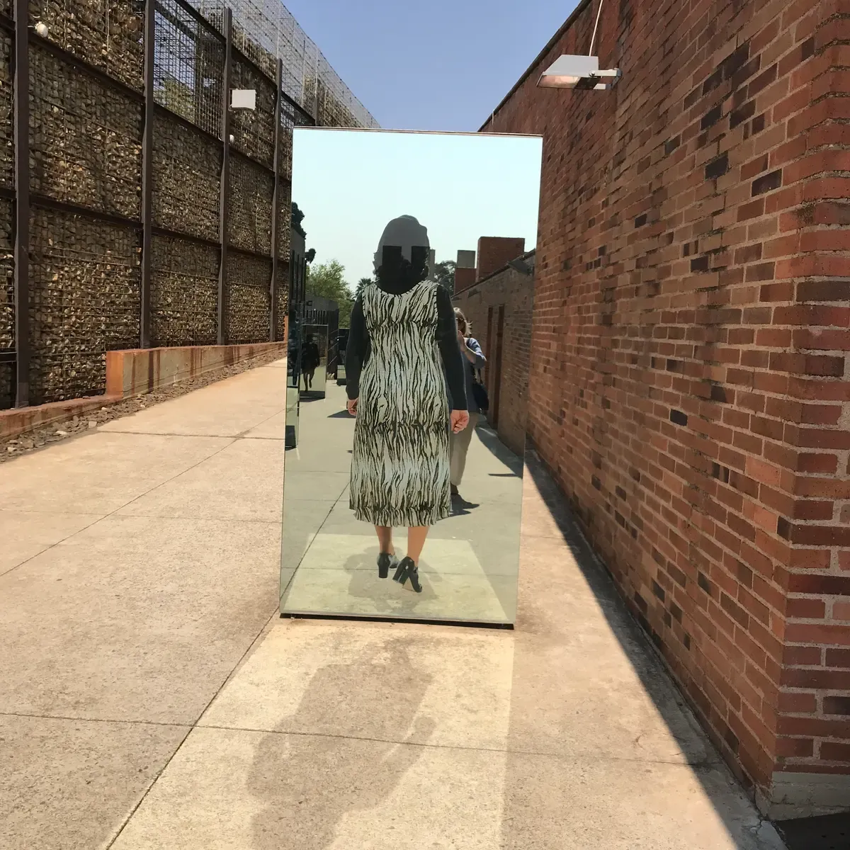 The Journeys exhibit at the Apartheid Museum, large portrait photographs along the outdoor route