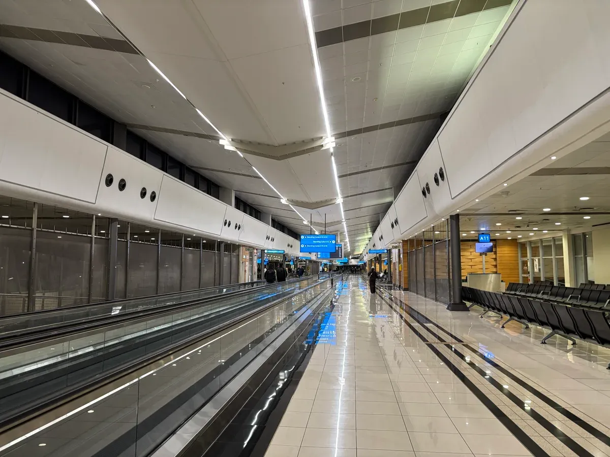 The airside concourse in Terminal A at OR Tambo International Airport, gates and seating in daylight